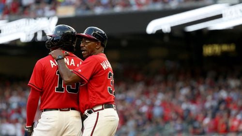 Atlanta Braves third base coach Ron Washington (37) talks with center fielder Ronald Acuna (13) after Acuna reached third base in the seventh inning Friday, Oct. 4, 2019, against the St. Louis Cardinals at SunTrust Park in Atlanta.