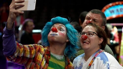 A Ringling Bros. and Barnum & Bailey clown takes a selfie with Jennifer and Kevin Fox, of Fort Pierce, Fla., during a pre show for fans Saturday, Jan. 14, 2017, in Orlando, Fla. The Ringling Bros. and Barnum & Bailey Circus will end the "The Greatest Show on Earth" in May, following a 146-year run of performances. Kenneth Feld, the chairman and CEO of Feld Entertainment, which owns the circus, told The Associated Press, declining attendance combined with high operating costs are among the reasons for closing. (AP Photo/Chris O'Meara)