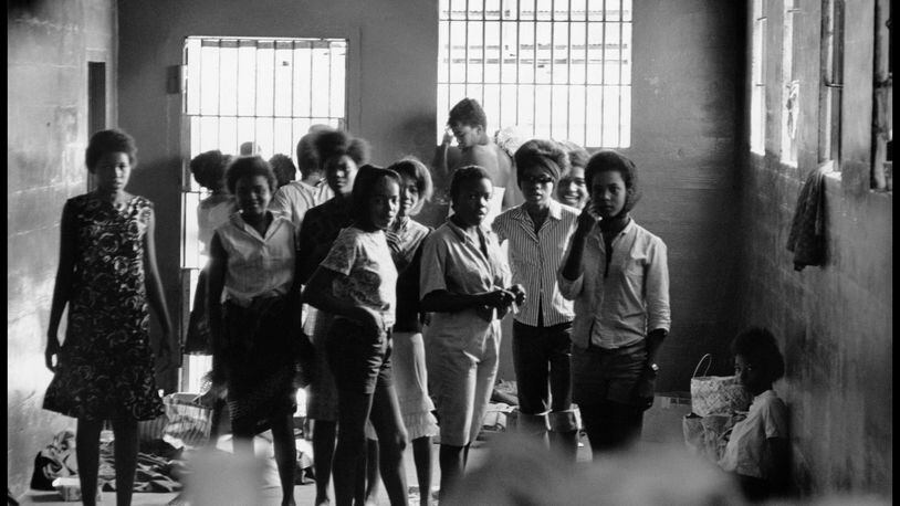 August 1963. Young women are held in the Leesburg Stockade after being arrested for demonstrating in Americus. They have no beds or sanitary facilities. Left to right — Melinda Jones Williams, Laura Ruff Saunders, Mattie Crittenden Reese, Pearl Brown, Carol Barner Seay, Annie Ragin Laster, Willie Smith Davis, Shirley Green and Billie Jo Thornton Allen. Sitting on the floor: Verna Hollis. Photo by and courtesy of DANNY LYON