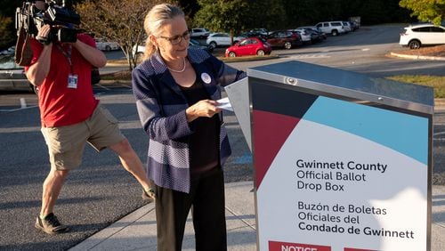 201020-Suwanee-Carolyn Bourdeaux, who is running for Georgia’s 7th congressional district, drops her ballot in a drop box at Georgia Pierce Park in Suwanee on Tuesday evening, October 20, 2020. Ben Gray for the Atlanta Journal-Constitution
