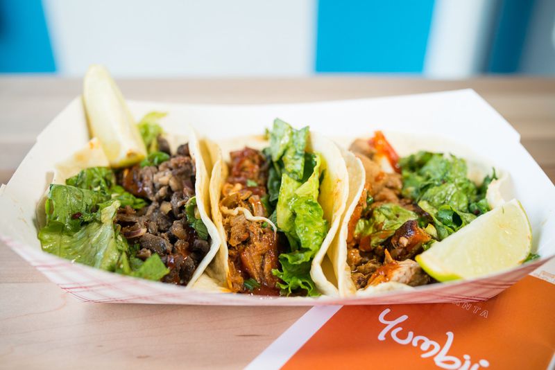 Spicy pulled-pork, Asian rib-eye beef, and chicken tacos at Yumbii. CONTRIBUTED BY MIA YAKEL