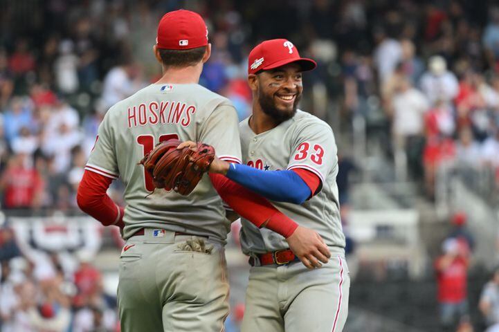 Philadelphia Phillies' Edmundo Sosa and Rhys Hoskins celebrate their victory after winning  game one of the baseball playoff series between the Braves and the Phillies at Truist Park in Atlanta on Tuesday, October 11, 2022. (Hyosub Shin / Hyosub.Shin@ajc.com)