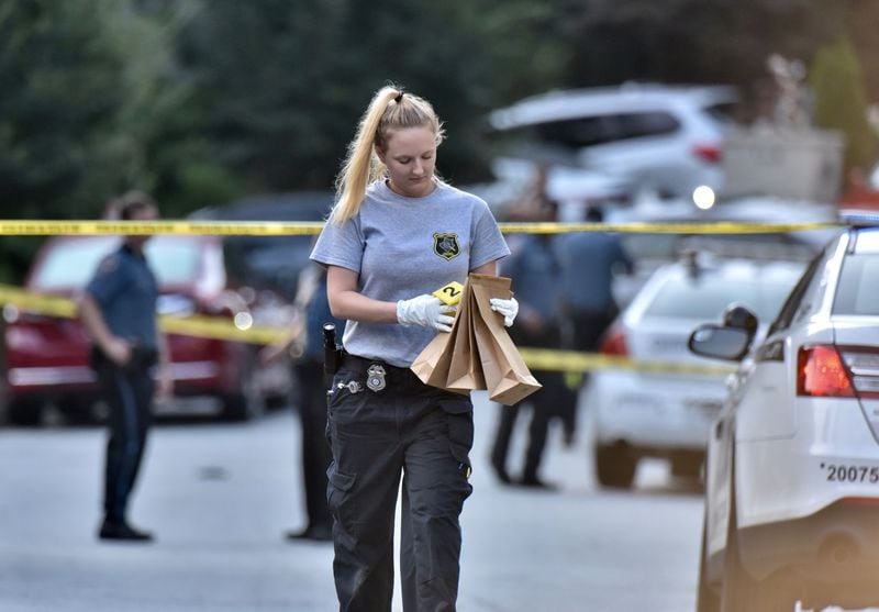 An investigator bags evidence at the scene Friday morning. 