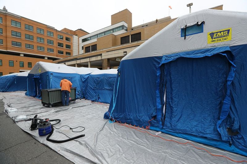 Tents and a mobile medical unit are nearing completion outside the emergency entrance at WellStar Kennestone Hospital. Curtis Compton ccompton@ajc.com