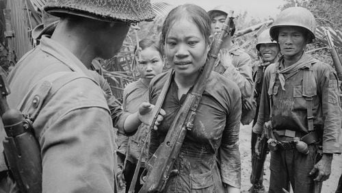 Suspected Viet Cong soldier carrying a Russian-made rifle, awaiting interrogation. August 25, 1965.
