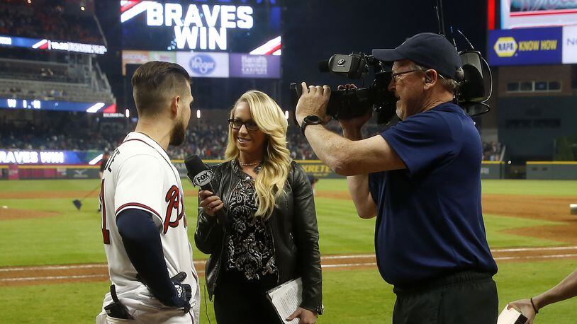 Braves center fielder Ender Inciarte is interviewed by Fox Sports South field reporter Kelsey Wingert after Inciarte's game winning squeeze bunt against the New York Mets April 21, 2018, at SunTrust Park in Atlanta.