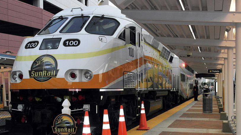 Locomotive pulls rail cars for SunRail, metro Orlando's new commuter line, which opened May 1.