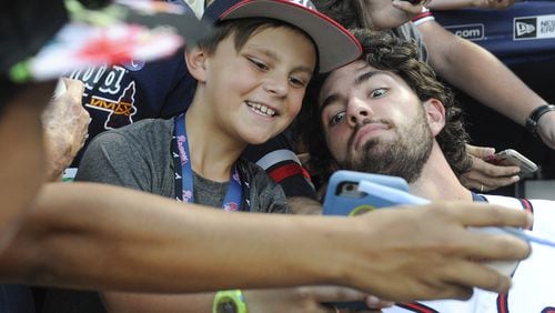 Atlanta Braves shortstop Dansby Swanson poses with 9-year-old fan Caleb Zurawick of Chattanooga, Tenn., before a game against the Philadelphia Phillies on Wednesday, Sept. 28, 2016, in Atlanta. (AP Photo/John Amis)