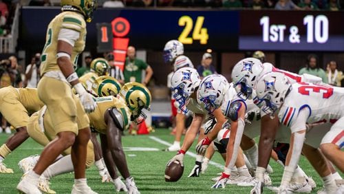Walton and Grayson line up on the line of scrimmage during the Corky Kell and Dave Hunter Classic on August 19, 2023. (Jamie Spaar for the Atlanta Journal Constitution)