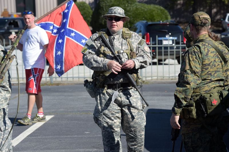 Armed militias, like the Georgia Security Force III% militia, are a fixture at right wing protests. KENT D. JOHNSON /AJC