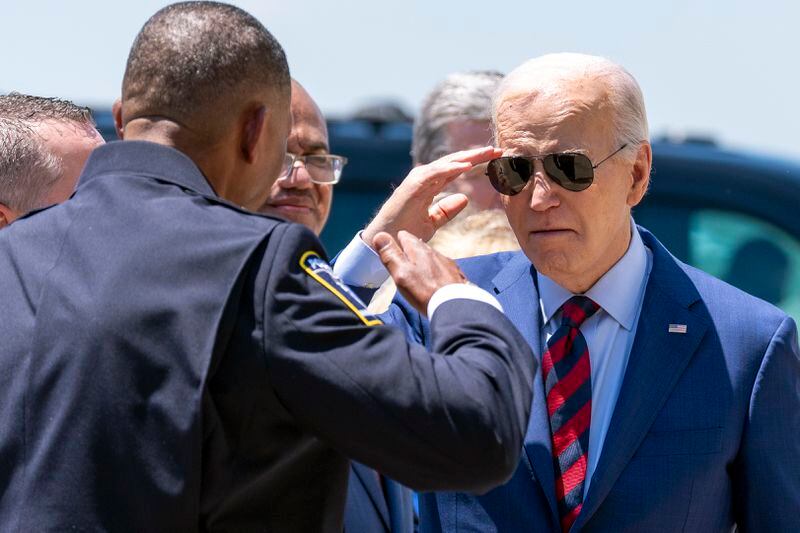 President Joe Biden salutes Charlotte-Mecklenburg Police Department Chief Johnny Jennings, as he arrives on Air Force One at Charlotte Douglas International Airport, Thursday, May 2, 2024, in Charlotte, N.C. Biden is meeting with the families of law enforcement officers shot to death on the job. (AP Photo/Alex Brandon)