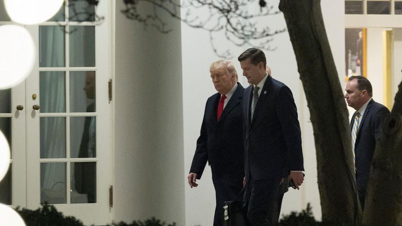 U.S. President Donald Trump speaks with White House Secretary Rob Porter (C) and Sen. Mike Lee (R-UT) (R) as they return to the White House December 4, 2017 in Washington, DC. (Photo by Chris Kleponis-Pool/Getty Images)