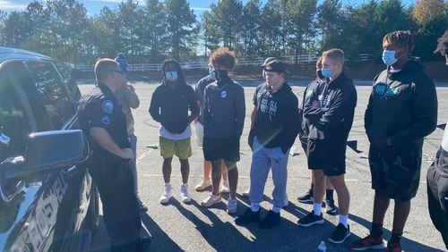 Officer Sam Wolfson and Sgt. Brittany Rodgers met with Roswell High School football team members and their parents. The officers told the teens what police are looking for during traffic stops and the teenagers got to ask questions about proper police procedures. Photo: Adrianne Murchison