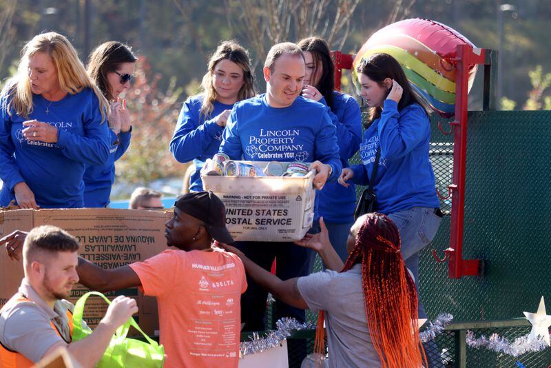 Employees with the Lincoln Property Company unload donations during the Food-A-Thon event at the Atlanta Community Food Bank, Friday, November 4, 2022, in East Point, Ga. (Jason Getz / Jason.Getz@ajc.com)