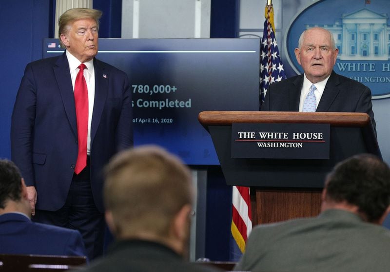 Secretary of Agriculture Sonny Perdue, right, speaks as President Donald Trump looks on during the daily briefing of the White House Coronavirus Task Force, at the White House in Washington, D.C., on Friday, April 17, 2020. (Alex Wong/Getty Images/TNS)
