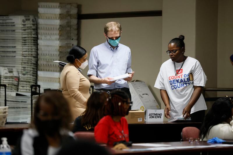 DeKalb County elections director Keisha Smiths (left) talks with election officials while poll workers prepare for the recount. Election officials announced that the recount of the votes for the District 2 would be by hand on Sunday, May 29. 2022. (Photo: Miguel Martinez / miguel.martinezjimenez@ajc.com)