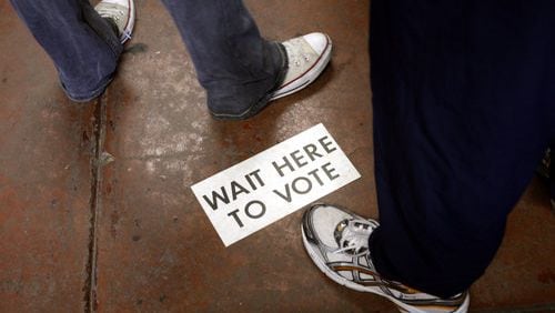 12:05 p.m. Atlanta: A sign on the floor of Atlanta Fire Department's station 20 in southwest Atlanta gives instructions for voters on Tuesday morning. The line snaked around the building in the morning, but by lunch had dwindled to about 15 people.