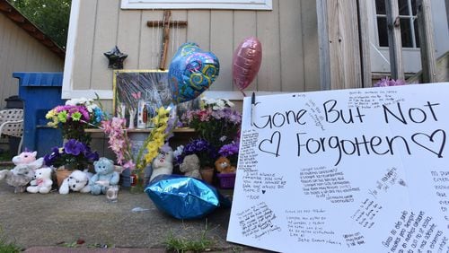 July 7, 2017 Loganville - Neighbors and friends placed flowers and messages Wednesday night during their gathering on the doorstep of a home where four children and their father were stabbed to death in Loganville on Friday, July 7, 2017. Gwinnett County mother Isabel Martinez was charged with multiple counts of murder in the stabbing deaths of four of her children and their father, law enforcement said. HYOSUB SHIN / HSHIN@AJC.COM