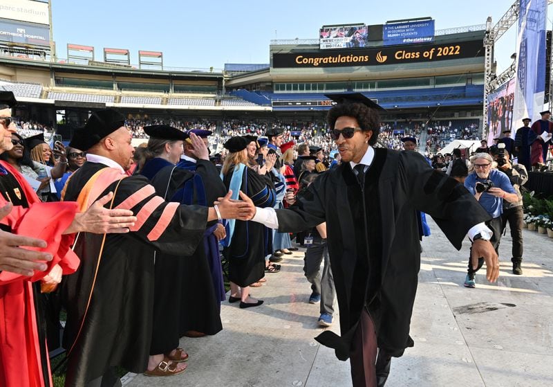Rapper and actor Chris “Ludacris” Bridges greets faculty members as he enters the commencement ceremony at Center Parc Stadium on Wednesday, May 4, 2022. Georgia State University awarded Chris “Ludacris” Bridges an honorary bachelor's degree.  (Hyosub Shin / Hyosub.Shin@ajc.com)