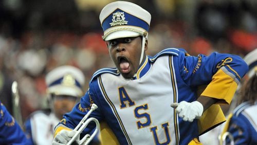 A member of Albany State University “Marching Rams Show Band” performs during a Honda Battle of the Bands at the Georgia Dome. The band will represent Georgia in the 2016 Rose Bowl Parade in January. HYOSUB SHIN/hshin@ajc.com