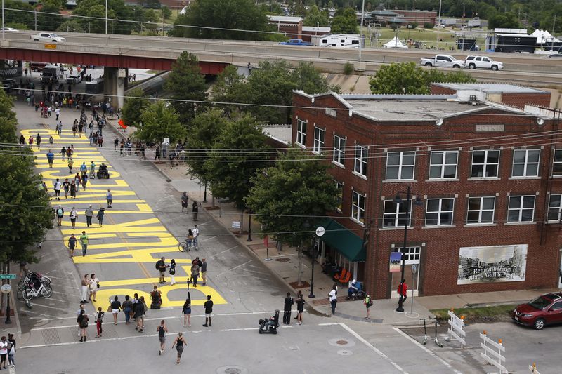 People walk along Greenwood Avenue on Friday in Tulsa, Oklahoma, where the words "Black Lives Matter" were painted on the road as people mark Juneteenth.