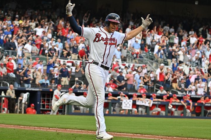 Atlanta Braves' Matt Olson hits a three-run homer during the ninth inning of game one of the baseball playoff series between the Braves and the Phillies at Truist Park in Atlanta on Tuesday, October 11, 2022. (Hyosub Shin / Hyosub.Shin@ajc.com)