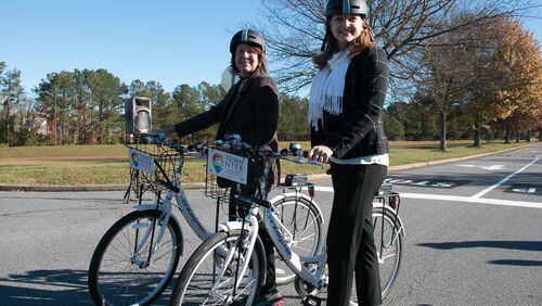 Faye DiMassimo, (left) the director of the Cobb County Department of Transportation, and Tracy Rathbone, (right) executive director of Town Center Community Improvement District pose with new Zagster bike share bicycles on Friday, Nov. 20, 2015. Photo courtesy of Town Center CID.