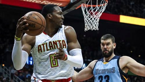Atlanta Hawks center Dwight Howard (8) looks to pass while being defended by Memphis Grizzlies center Marc Gasol (33) during the second half of am NBA game, Thursday, March 16, 2017, in Atlanta. The Grizzlies defeated the Hawks 103-91. (AP Photo/Branden Camp)