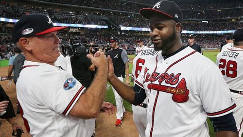 Braves manager Brian Snitker and closer Arodys Vizcaino share a little relief and happiness following the NLDS Game 3 victory over the Dodgers. (Curtis Compton/ccompton@ajc.com)