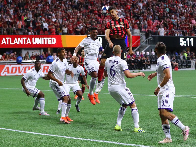 Atlanta United defender Miles Robinson trys to head a corner kick into the net against a host of Orlando City defenders Sunday, May 12, 2019, in Atlanta.  