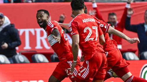 Chicago Fire forward Kellyn Acosta, left, celebrates with teammates Hugo Cuypers, center, and Kendall Burks (27) after scoring his game winning goal during the second half of an MLS soccer match against CF Montréal, Saturday, March 16, 2024, in Chicago. (AP Photo/Matt Marton)