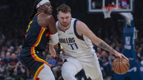 Dallas Mavericks guard Luka Doncic (77) drives against Oklahoma City Thunder guard Luguentz Dort during the first half of Game 5 of an NBA basketball second-round playoff series, Wednesday, May 15, 2024, in Oklahoma City. (AP Photo/Nate Billings)