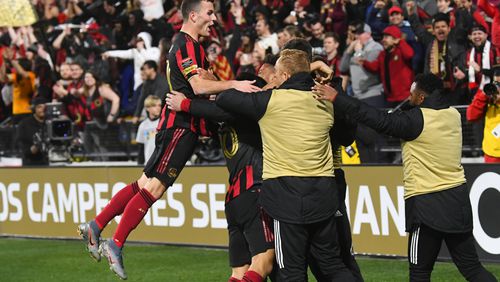 Atlanta United defender Brooks Lennon leaps to join the celebration of a goal by Gonzalo Martinez during the second half of a soccer match against Motagua FC in the Scotiabank Concacaf Champions League, Tuesday, Feb. 25, 2020, in Kennesaw, Ga. Atlanta United won 3-0. (John Amis, Atlanta Journal Constitution)