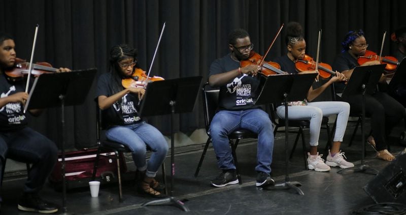 Students who are part of the Atlanta Music Project rehearsed as they waited for Atlanta hip-hop artist T.I., who they accompanied during a 2018 Tiny Desk Concert on NPR. BOB ANDRES / BANDRES@AJC.COM