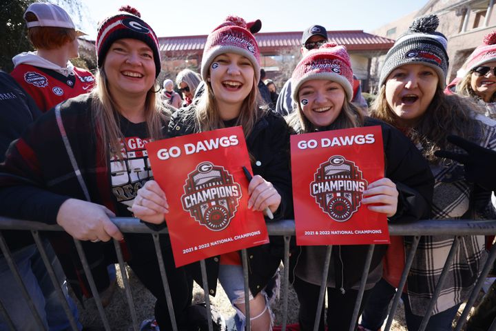 Georgia Bulldogs fans (l-r) Jennifer Lovejoy, Adelyn Lovejoy, Kinsey Hugely, and Jennifer Hugely cheer while celebrating Georgia’s College Football Playoff national championship during the victory parade in Athens on Saturday, January 14, 2023.  Miguel Martinez / miguel.martinezjimenez@ajc.com