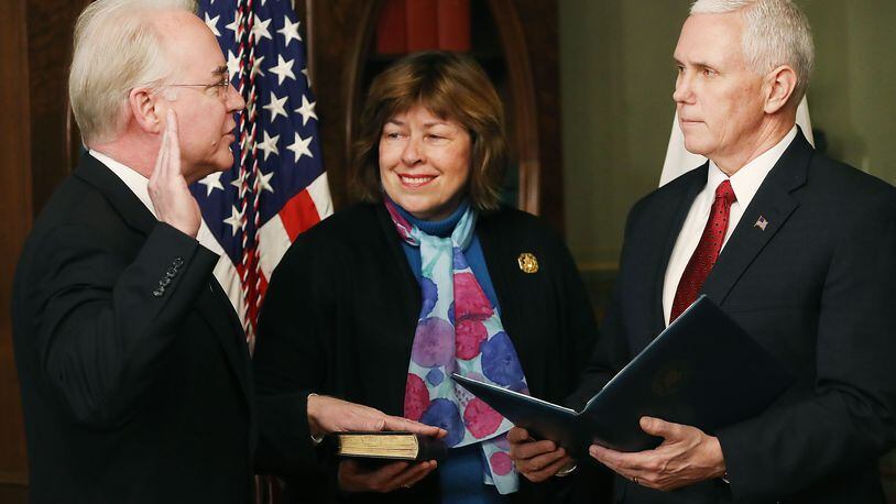 Vice President Mike Pence, right, administers the oath of office Friday to Tom Price to become the nation’s 23rd secretary of health and human services. Price’s wife, Betty, holds a Bible as the Roswell Republican takes the oath. (Photo by Mark Wilson/Getty Images)