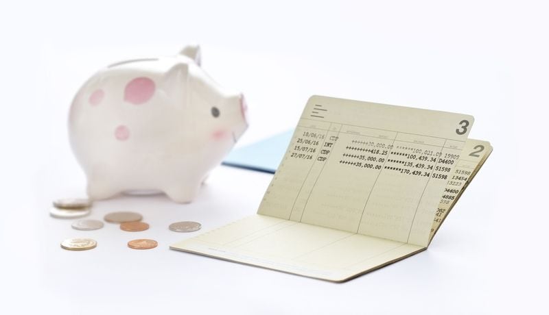Saving account passbook, book bank and piggy bank on white background