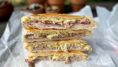 Buena Gente Cuban Bakery makes its own sandwich bread for its pressed sandwiches, such as the croqueta preparada (top two wedges) and the classic Cuban (bottom two). Wendell Brock for The Atlanta Journal-Constitution