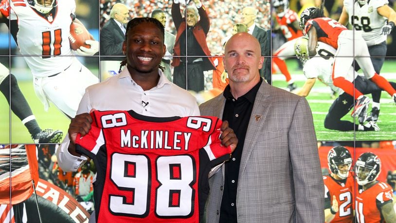 Takkarist McKinley shares the stage with his new head coach, the Falcons Dan Quinn. (Photo courtesy of AtlantaFalcons.com)
