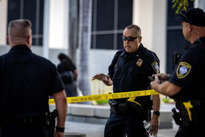 Police officers confer while taking up their posititions at the Wilkie D. Ferguson Jr. U.S. Courthouse in Miami on Tuesday morning, June 13, 2023. (Christian Monterrosa/The New York Times)