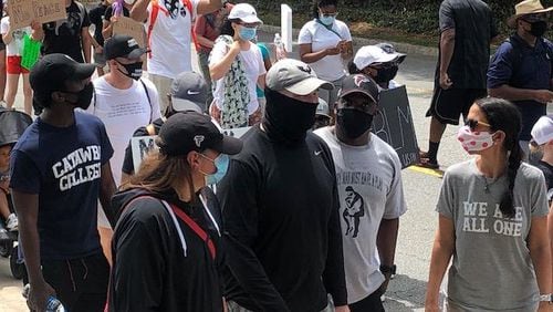 Falcons coach Dan Quinn and wife, Stacey (to his right), take part in a protest in Buckhead on Sunday, June 7, 2020.  D. Orlando Ledbetter/dledbetter@ajc.com)