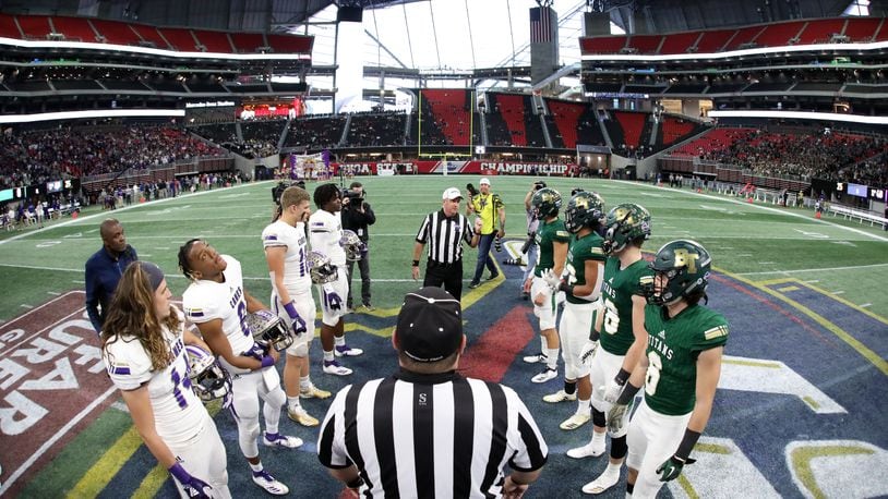 Class AAAA title game: Cartersville players (left) and Blessed Trinity players participate in the coin toss with officials before the start of the Class AAAA State Championship game at Mercedes-Benz Stadium Wednesday, December 12, 2018, in Atlanta. (Jason Getz/Special to the AJC)