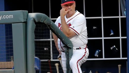Braves manager Brian Snitker looks out from the dugout during Tuesday’s game against the Pirates. (AP Photo/John Bazemore)