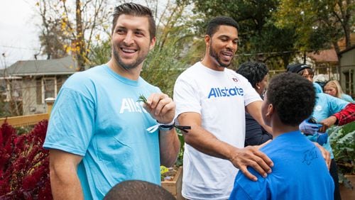 Former SEC quarterbacks Florida's Tim Tebow (left) and Auburn's Jason Campbell took part in a community event at an Atlanta Boys and Girls Club Thursday.