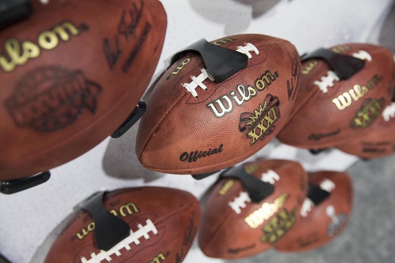 The Wilson booth displays replica footballs from an array of past Super Bowl games during the Super Bowl LIII Fan experience at the Georgia World Congress Center in Atlanta, Monday, January 28, 2019. (ALYSSA POINTER/ALYSSA.POINTER@AJC.COM)