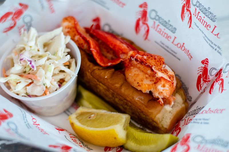 Large chunks of lobster are immediately apparent in the classic Maine lobster roll at Cousins Maine Lobster in Lenox Square mall. CONTRIBUTED BY HENRI HOLLIS