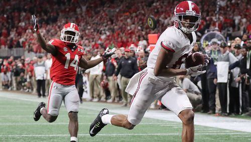 Alabama wide receiver Devonta Smith catches the game-winning touchdown pass past Georgia defensive back Malkom Parrish for a 26-23 victory during overtime in the College Football Playoff Championship game Monday, January 8, 2018, in Atlanta.  Curtis Compton/ccompton@ajc.com