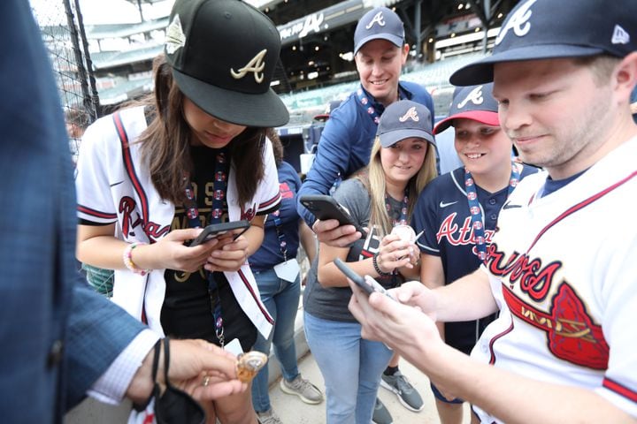 Braves fans got a chance to hold and take photos of a World Series ring Monday at Truist Park. (Miguel Martinez/miguel.martinezjimenez@ajc.com)