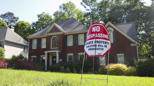 No trespassing signs are shown at the home at in Powder Springs, where a man illegally moved into the home before being arrested last week. (Jason Getz / AJC)