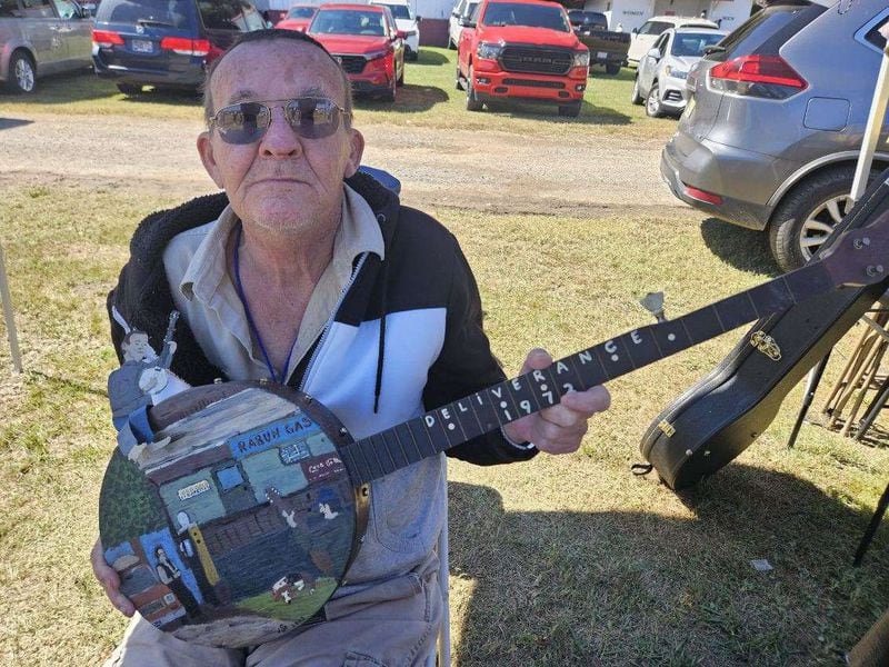 Billy Redden at Hazzard Fest in Newport, Tennessee in 2023 with a banjo created by an artist Jeff Carlise with a stained glass design in honor of Redden as a gift. KIP RAMEY